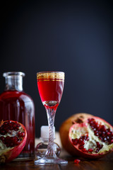 sweet pomegranate alcoholic cordial in the decanter with a glass