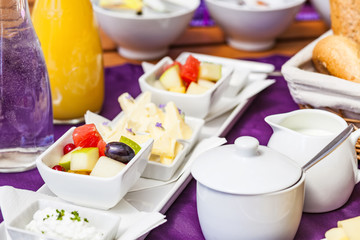Fresh Breakfast or brunch with ham, eggs, bread, yogurt, fruits and coffee