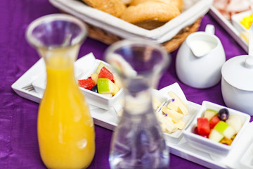Fresh Breakfast or brunch with ham, eggs, bread, yogurt, fruits and coffee