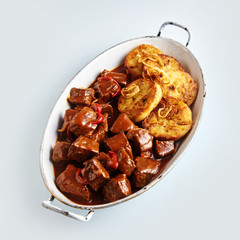 Tasty spicy beef goulash with dumplings