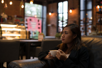 Young woman relaxing drinking coffee at cafe.