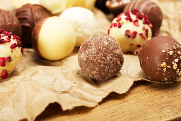 Selection of delicious chocolates on a rustic background