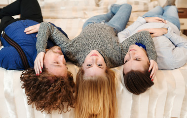 Friends laughing - Young people on bed, close friends