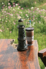 Lighthouse model with coffee cup