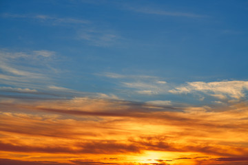 Sunset sky orange clouds over blue