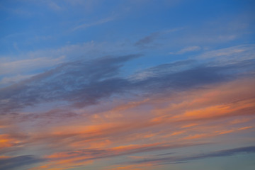 Sunset sky orange clouds over blue