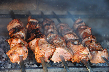 Preparing fresh beef steak shishkabobs with vegetables on grill
