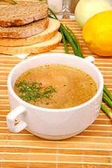 fish soup with parsley in the white plate