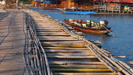 Boats next to the bamboo bridge crossing the river / Sanklaburi / Karnjana buri / Thailand