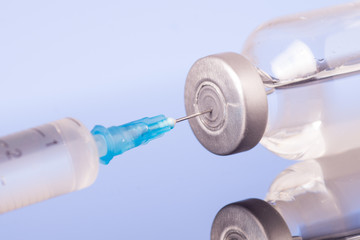 Medical syringe with the needle in the vial