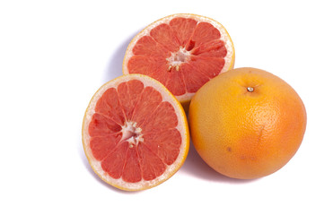 red grapefruit one whole and two half isolated on white background