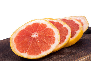 Fototapeta na wymiar Fresh red grapefruit rings set isolated on wooden board on white background.