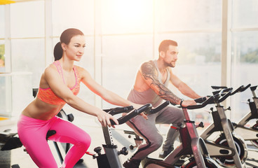 Fototapeta na wymiar Man and woman, couple in gym on exercise biles