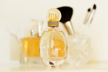 perfume and makeup brushes on a  table, close-up
