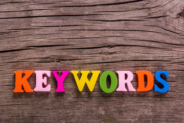 Fototapeta premium keywords word made from colored wooden letters on an old table. Concept