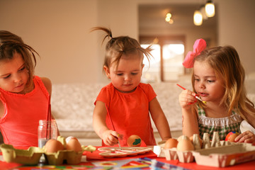 Kids Easter preparation by painting Easter eggs.
