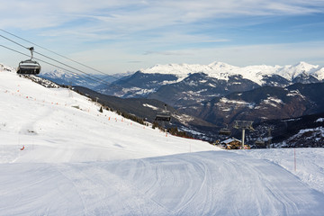 View of an alpine ski slope with chairlift