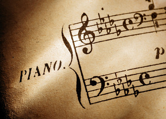 antique music sheet with music clefs