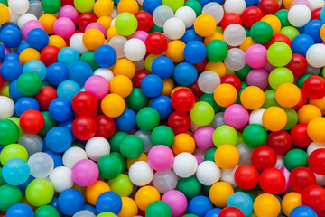 Colored plastic toy balls of different color for the children's pool dry. Picture background, wallpaper, texture, pattern.
