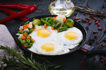 Delicious, tasty fried and mix vegetables on a pan. Top view of a wooden background. Close-up