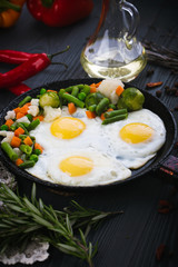 Delicious, tasty fried and mix vegetables on a pan. Top view of a wooden background. Close-up