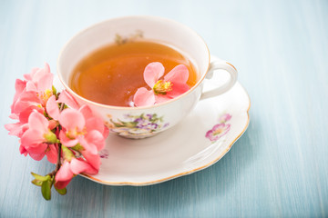 chamomile tea in a glass cup on wooden background