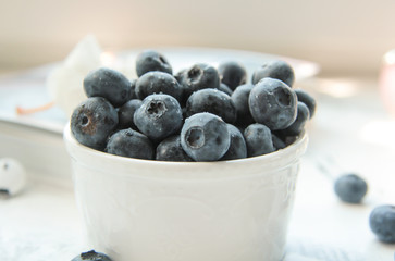 a Cup of fresh blueberry on a Sunny table