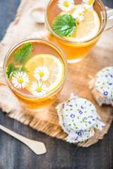 chamomile tea in a glass cup on wooden background