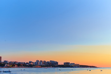 Fototapeta premium Big City by the sea at sunset 