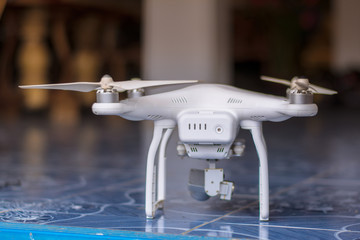 White drone, quadrocopter with photo camera flying concept.