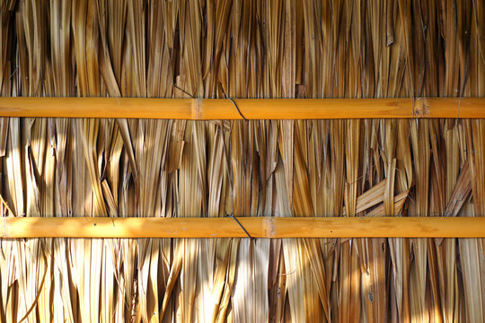 House's wall made from dried leaves of the nipa palm and bamboo. old wall textured background.