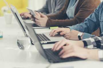 Group of People Typing on Laptops