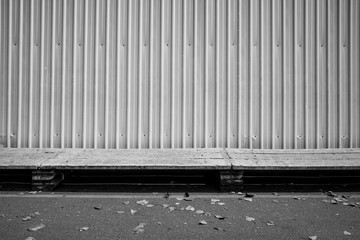 Steel wall and concrete pathway in black and white