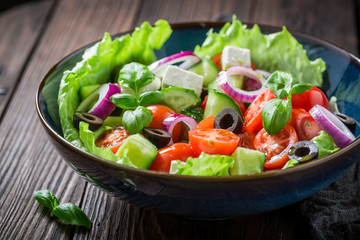 Delicious Greek salad with feta cheese, black olives and lettuce