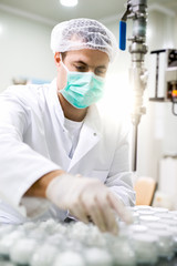 Protective worker at pharmaceutical factory on his work place.