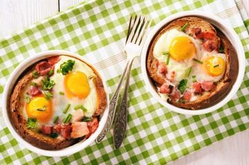 Eggs baked with bacon, tomatoes, garlic and bread.