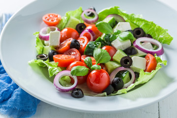 Tasty Greek salad with feta cheese, black olives and lettuce