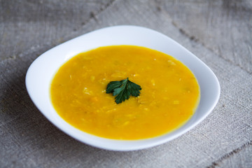 Soup with pumpkin, potatoes, cream, cheese and chicken. First course.