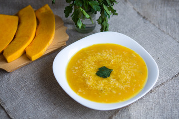 Soup with pumpkin, potatoes, cream, cheese and chicken. First course.