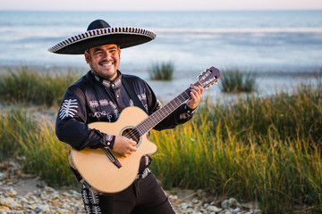 Mexican musician, a guitarist on the beach.