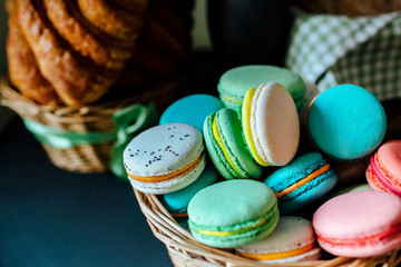 Sweet colourful french macaroons and  Croissants
