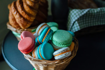 Sweet colourful french macaroons and  Croissants