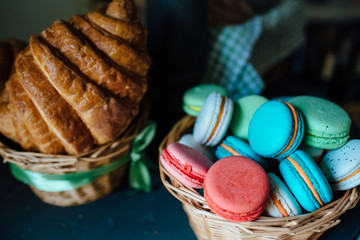 Sweet colourful french macaroons and  Croissants