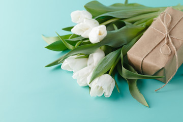 Small romantic present on table with tulips
