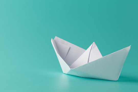 paper boat on aquamarine background