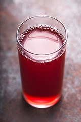 Berry juice on the metal background vertical