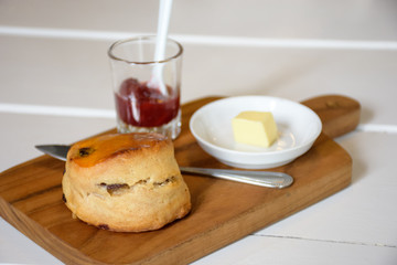 Delicious scone with butter and strawberry jam