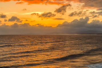 Naklejka na ściany i meble ocean and seascape in beautiful orange sunset