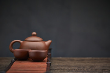 Traditional tea ceremony accessories, teapot and teacup with wooden background