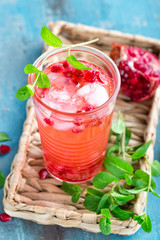 Infused pomegranate water with fresh lemon and ice, cold healthy refreshing and detox drink